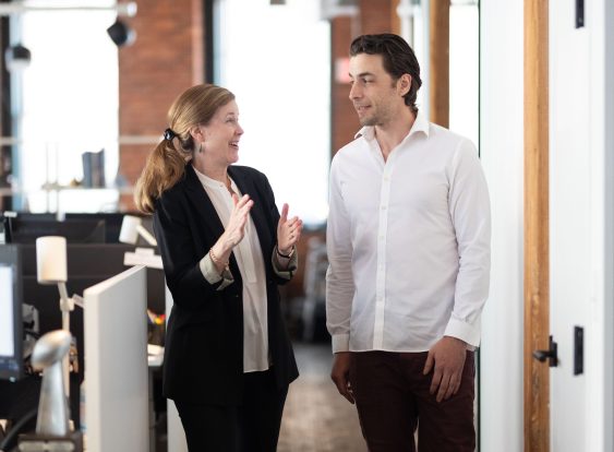 Ben Strong speaking with colleague