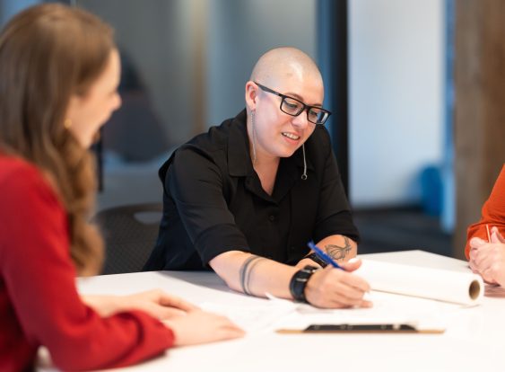 Alyson Grigoli working with colleagues