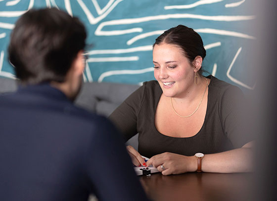 Liz Forester speaking with a colleague