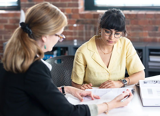 Parvaaz Godara speaking with a colleague