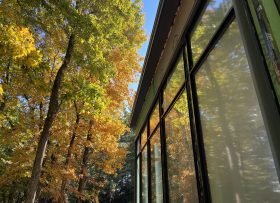 Side of a building with fall folliage